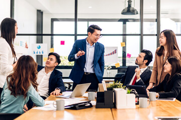 Group of asian business meeting and discussing strategy startup project analysis finance process.Success business people work plan and brainstorm marketing idea with laptop in office.Teamwork