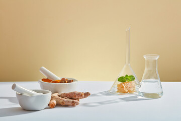A front view of honey and turmeric extract with laboratory equipment in beige background for...
