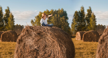 Child sitting on hay bale in a field.