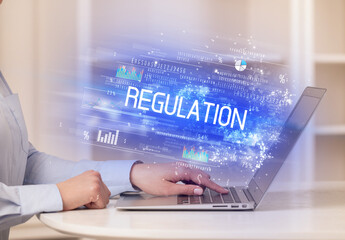 Closeup of businessman hands working on laptop
