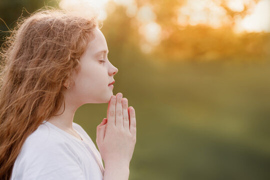 Little girl folded her hand in praying.