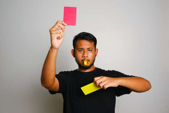 A picture of man showing yellow to red card on after 2nd bookable offence. Law violation and misconduct concept.