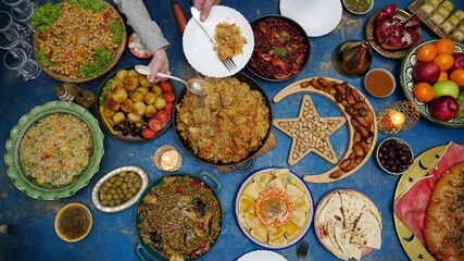 Ramadan iftar Eid. Muslim family has dinner at home. Table with traditional food. Eid al-Fitr celebrations