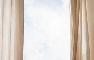 Window with fluttering curtains. Bright sky frame for copy space. Open to the wind blow of summer...