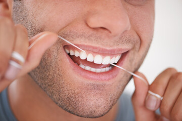 Oral hygiene. Cropped shot of a man flossing his teeth.