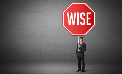 Young business person holding road sign