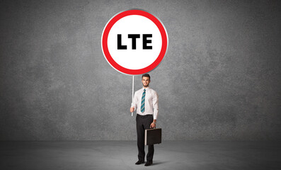 Young business person holdig traffic sign