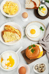 Various ways of cooking chicken eggs on light background.