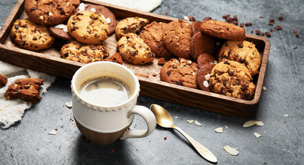 Plate with chocolate cookies and cup of hot coffee. Sweet dessert.