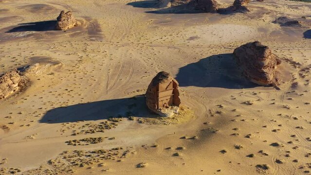 Aerial view towards Madain Saleh, Al-Ḥijr or Hegra, archaeological site located in Al-Ula, Al Madinah Region, Hejaz, Saudi Arabia - approaching, drone shot