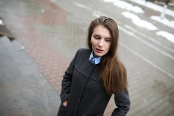 Young adult girl in coat on the street