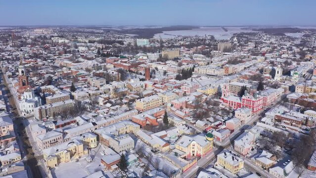 Scenic aerial view of covered with snow houses and churches in Russian city of Yelets on sunny winter day, Lipetsk Oblast