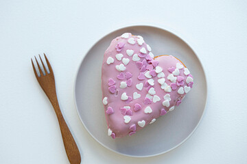 Fototapeta na wymiar Heart shaped donut on white background