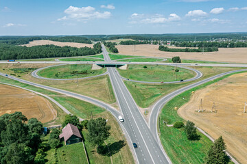 Fototapeta na wymiar highway road intersection in countryside. aerial view in sunny summer day.