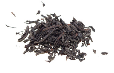 Dried black tea leaves on a white background.