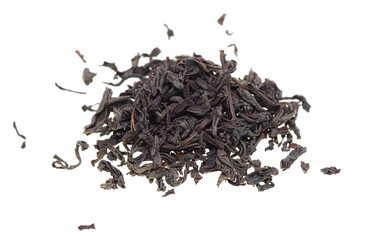 Dried black tea leaves on a white background.