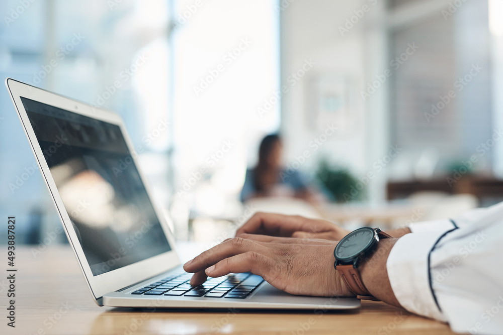 Aufkleber Hell find what he needs on the net. Closeup shot of an unrecognisable businessman using a laptop in an office.