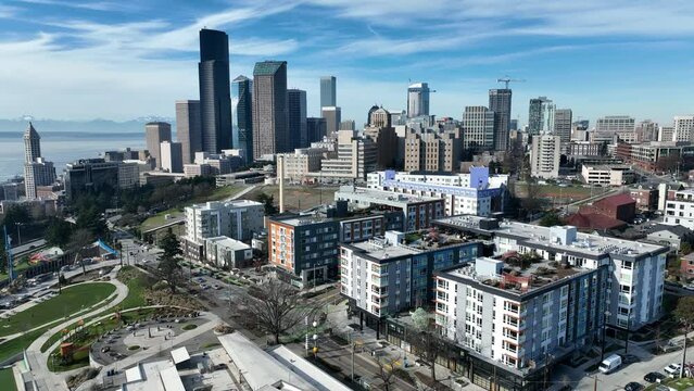 Cinematic 4K aerial drone rise and reverse shot of First Hill, Yesler Terrace, Atlantic, Cherry Hill, Squire Park, skyscrapers and high-rise buildings downtown Seattle, Washington