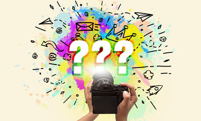 Close-up of a hand holding digital camera with abstract drawing concept