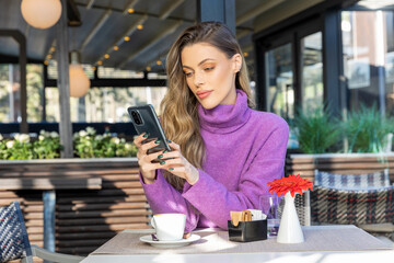 Beautiful woman texting alone in the cafe bar