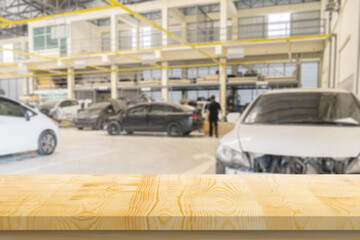 Empty wood table top with car service centre auto repair workshop blurred background