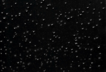 Randomly scattered air bubbles close-up, macro. Silvery metallic balls of mercury
