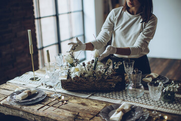 Table setting. A woman decorates the table for the holiday. High quality photo