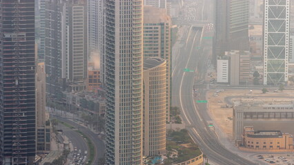 Bussy traffic on a road intersection in Dubai downtown aerial timelapse.