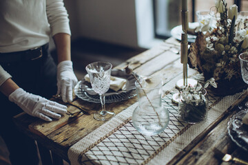 Table setting. A woman decorates the table for the holiday. High quality photo