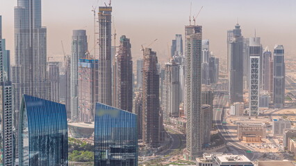 Aerial view of tallest towers in Dubai Downtown skyline and highway timelapse.