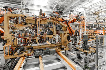Photo of automobile production line. Welding car body. Modern car assembly plant. Auto industry. Interior of a high-tech factory, modern production
