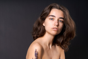 Unshaven armpit concept. Girl is holding lavender flowers in front her armpits. Symbol of unshaven...