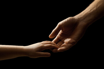 Man with child on black background, closeup of hands - Powered by Adobe