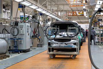 Car bodies are on assembly line. Factory for production of cars. Modern automotive industry....