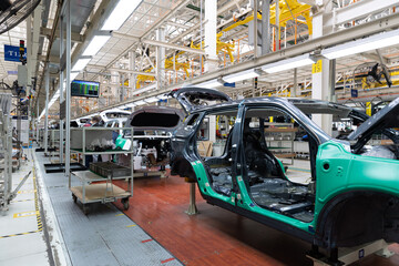 Photo of automobile production line. Welding car body. Modern car assembly plant. Auto industry....