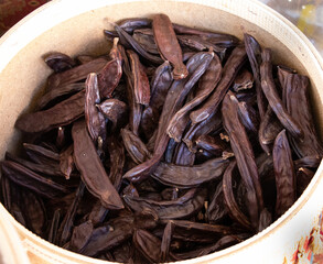 Organic and healthy carob in market stall, carob, close up 