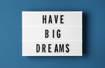 Lightbox with motivational quote Have Big Dreams on blue background, top view