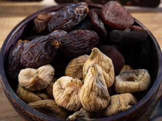 Dried fruits in bowl, of figs, apricots and dates, close up