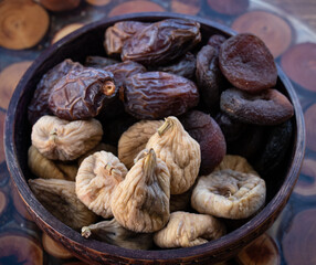 Dried fruits in bowl, of figs, apricots and dates, close up