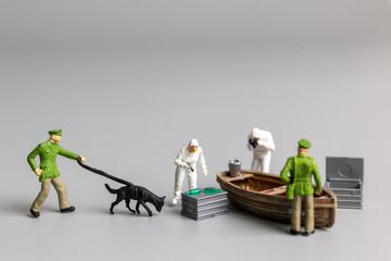 Miniature people Police And Detective are working on the boat , Crime scene investigation concept