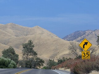 Warning sign and speed limit on a dangerous curve at California State Route 178.