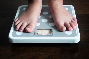 Straight view of feet on weight scale . Weight loss concept.