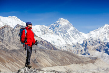 Fototapeta na wymiar Active hiker hiking, enjoying the view, looking at Himalaya mountains landscape. mountaineering sport lifestyle concept