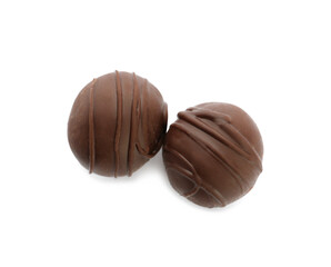 Delicious sweet chocolate truffles on white background, top view