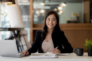 Beautiful Asian woman is a businesswoman who leads a new generation of startups, a woman who runs and manages a business plan to build confidence and stability in business, woman-led business concept.