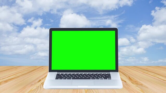 Green screen laptop computer with time lapse of clouds moving