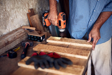 Man assembling furniture and fixing it - hobby concept.