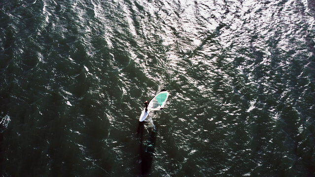 Surfboarding on a city urban river. Drone aerial photo. © astrosystem