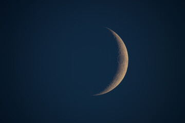 Obraz na płótnie Canvas Young Moon on a dark sky photographed with astronomical telescope.