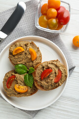 Slices of fresh bread with delicious pate and tomatoes on white wooden table, flat lay